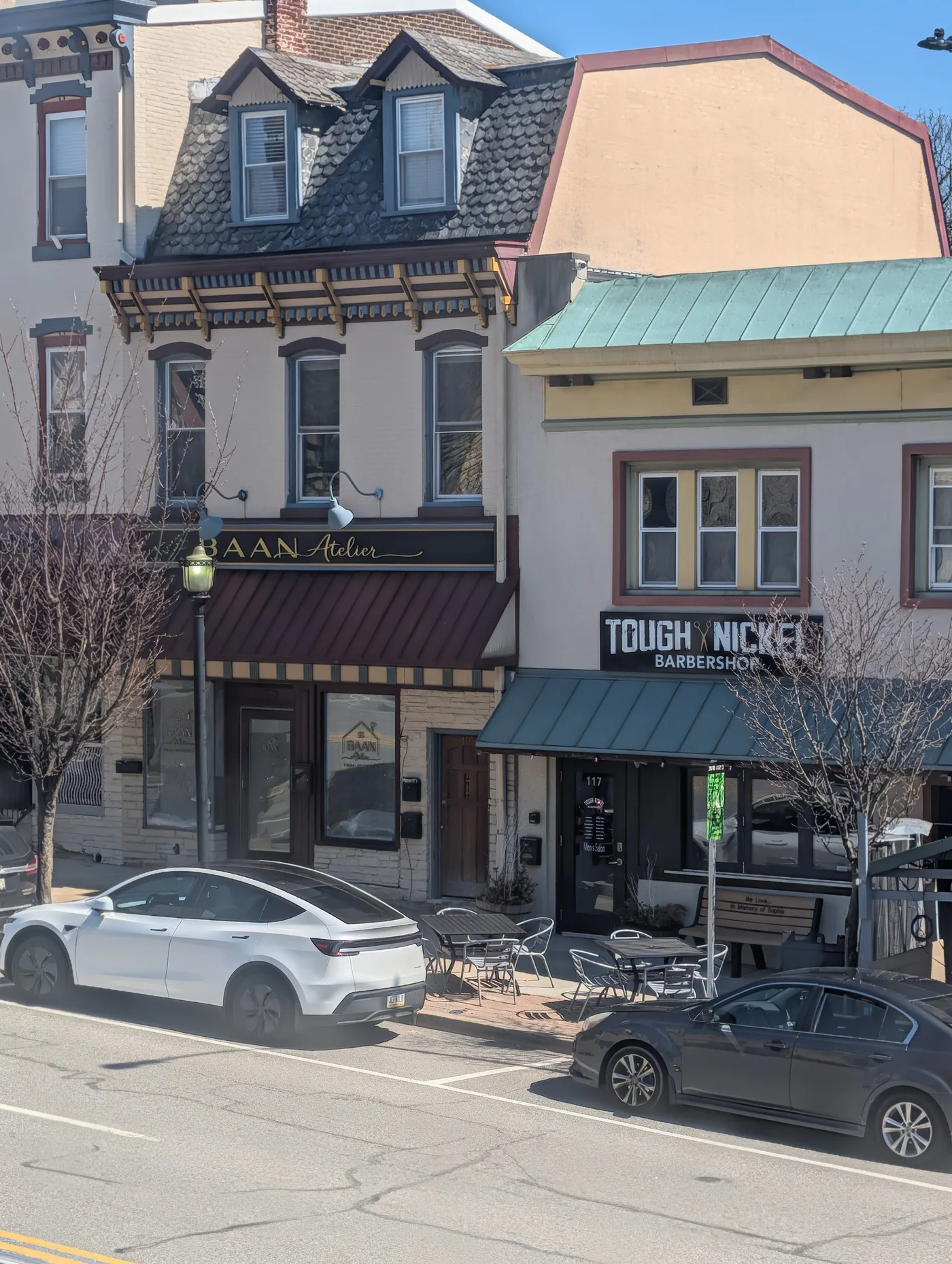 Downtown Conshohocken storefronts along a sunlit street.