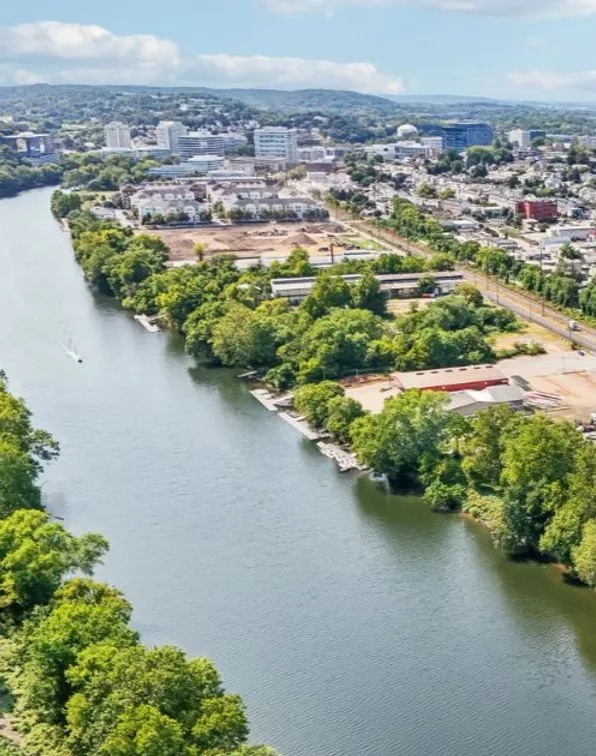 Riverfront view of Conshohocken with a blue architectural overlay.